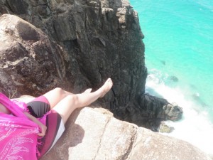 Kenna hanging her feet over the cliff at Indian Head