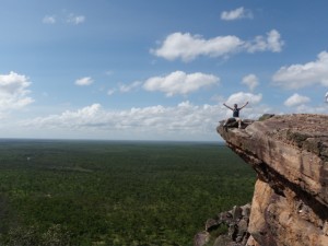 Scott sitting on the edge of a cliff overlooking Kakadu