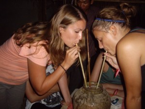 Kenna sucking on our "small" jar of Lao Lao rice whiskey